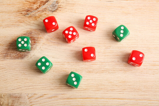 Different game dices on wooden background