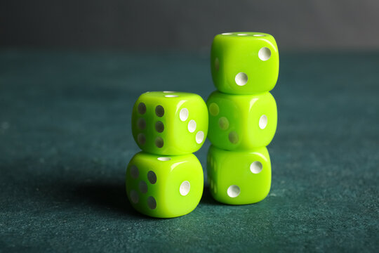 Green dices on color background