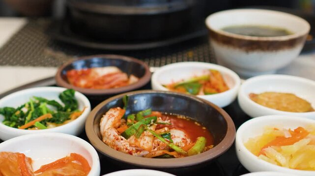 Traditional Korean Banchan Side Dishes and Kimchi on Restaurant Table