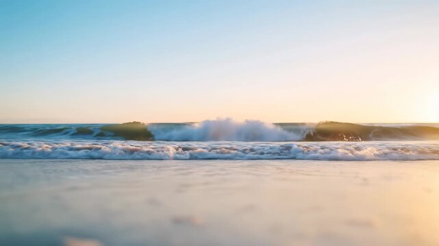 Slow motion tracking shot of ocean waves rolling and breaking onto sandy beach shoreline at sunrise golden light