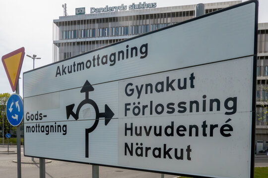 Stockholm, Sweden A road sign on the  exterior of the Danderyd Hospital points to the emergency room, gynecology, and main entrance. l.