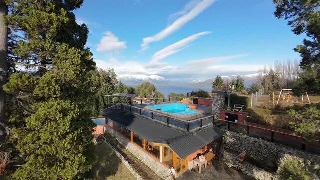 R&iacute;o Correntoso in Villa La Angostura Neuqu&eacute;n Patagonia Argentina with lakeside lodges, forested slope and Lake Nahuel Huapi nearby captured in fast FPV acro drone flight dynamic forward motion