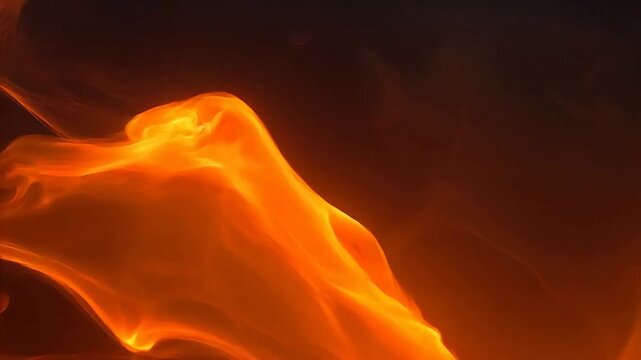 Abstract close-up of vibrant orange and yellow flames with a smoky texture against a dark background