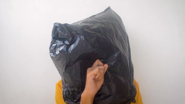 A man with a black plastic bag over his head, conveying a sense of despair or suffocation