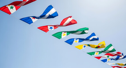 Obraz premium Colorful flags waving against a clear blue sky