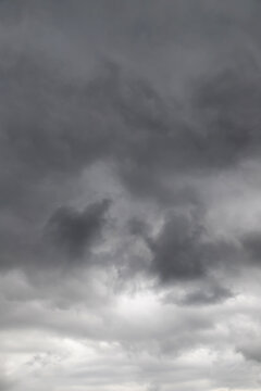 Dark storm clouds gathering in an overcast sky creating a dramatic, moody and foreboding atmosphere