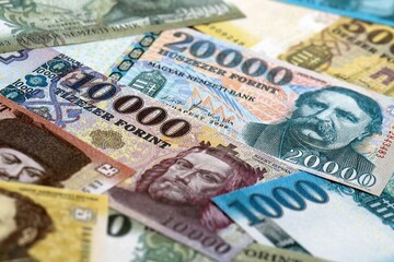 Obraz premium Hungarian forint money bills pile on table. Hungary banknotes of HUF currency close up.