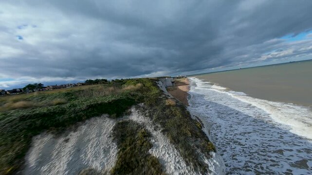 Drone flying low over botany bay beach and white cliffs
