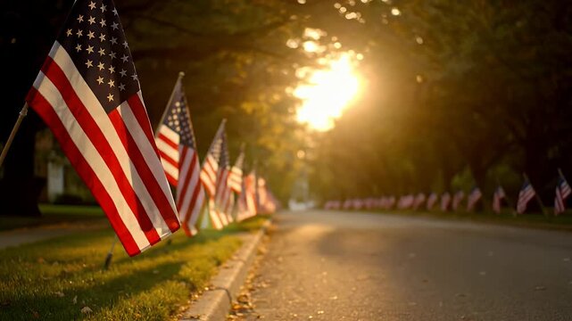 American flags on a suburban street lined up for memorial day at sunset in the park.