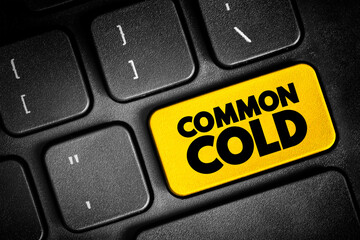 Naklejka premium Common Cold is a viral infection of your nose and throat, upper respiratory tract, text button on keyboard, concept background