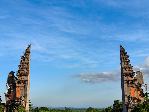 Traditional Balinese Candi Bentar Split Gate with Blue Sky Background