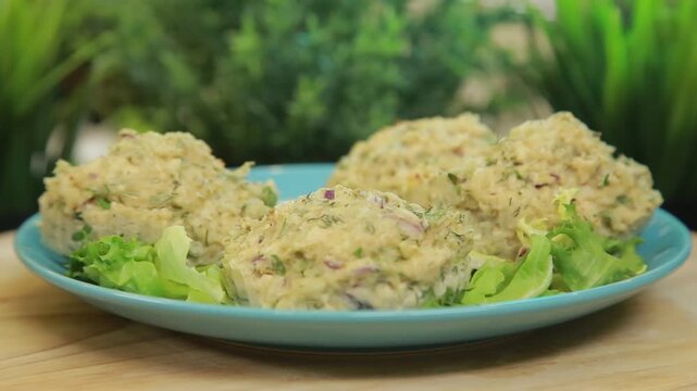 Baked fish muffins plated and served on a dish with fresh lettuce leaves