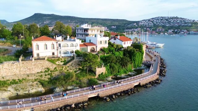 Scenic coastal town with white buildings and yachts in a clear blue bay. Turkey, Izmir, Eski Foca