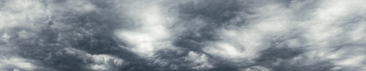 Fototapeta premium panoramic dark sky background. Heavy dark gray clouds in the overcast sky.