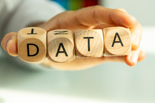 Conceptual image of wooden blocks spelling DATA held by hand.