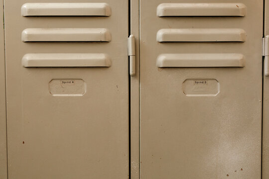 Detail of vintage school lockers showing ventilation slots and identification tags
