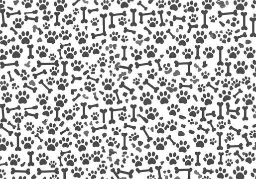 Seamless pattern of black dog paw prints and bones on white background