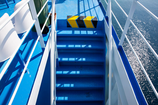 Ferry boat staircase at Aegean sea. Ship deck with blue stairs