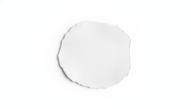 Circular torn paper scrap with deckle edges isolated on white background providing copy space for creative design and marketing messages featuring textured white fiber and soft shadow for depth.