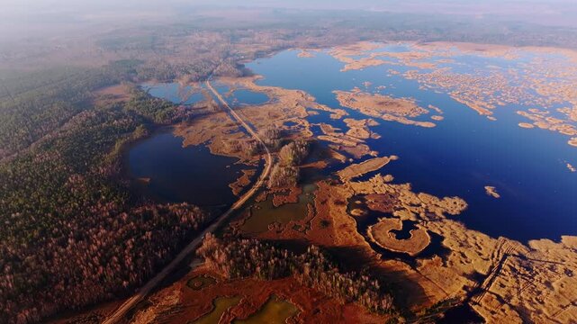 Establishing shot of overgrown lake wetlands with islands Kanieris Latvia