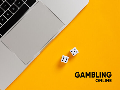 Laptop and dice representing online gambling concept