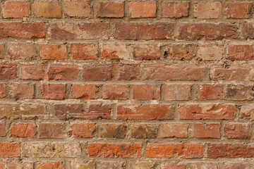 Fototapeta premium Close up detailed view of an old rustic weathered red brick wall