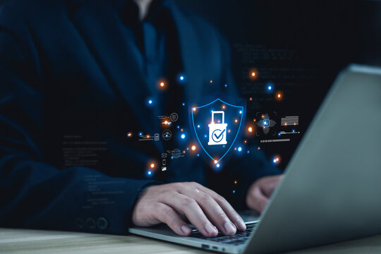 Businessman working on laptop with cybersecurity shield and padlock icon, data protection concept, secure network, encryption technology, online privacy, digital security system and cyber defense