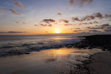 Obraz premium Amazing colorful sunset over the Ponta Preta beach (Black tip beach) on the southern part of the beautiful island of Sal in Cape Verde. The popular beach is isolated and deserted but gives amazing vie