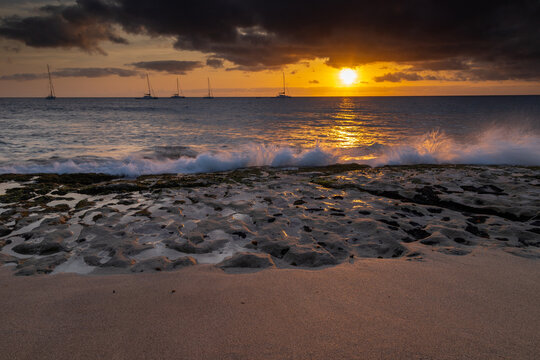 A spectacular sunset over the golden sand and Atlantic ocean seen from the popular Bikini beach at the island of Sal in Cape Verde. It is a nice stretch of beach with a calm cove area that's great for