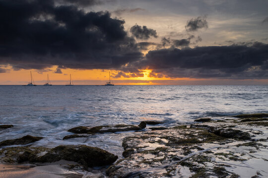 A spectacular sunset over the golden sand and Atlantic ocean seen from the popular Bikini beach at the island of Sal in Cape Verde. It is a nice stretch of beach with a calm cove area that's great for