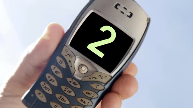 mobile telephone in hand with numbers on screen