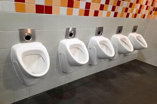 Modern Public Restroom Design Featuring Row of Clean Wall-Mounted Urinals