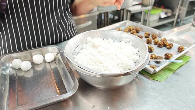 Process of hand-crafting traditional Asian sago dumplings on a metal tray.