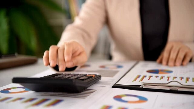 Professional accountant using calculator for financial analysis, business woman hands calculating data on paper reports, corporate tax and budget planning