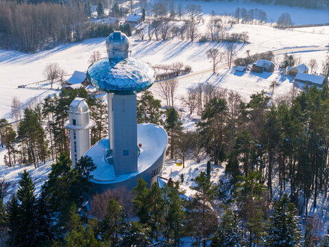 Aerial view of the Lithuanian Museum of Ethnocosmology with its futuristic glass domes and observatory towers surrounded by snow-covered pine forests in Kulionys, Utenos apskritis, Lithuania.