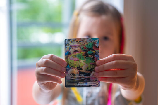 Child holding Pok&eacute;mon trading cards, focus on cards, Card Collection, Childhood Hobbies, youth culture and leisure, Gaming and Fan Entertainment, Battle with friends, Frankfurt - May 30, 2025