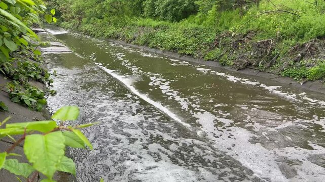 Toxic sewage water pouring from large concrete pipes of a city wastewater treatment facility