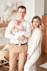 Fototapeta premium Loving Parents with Newborn Baby in Cozy Nursery Room at Home Lifestyle Family Moment