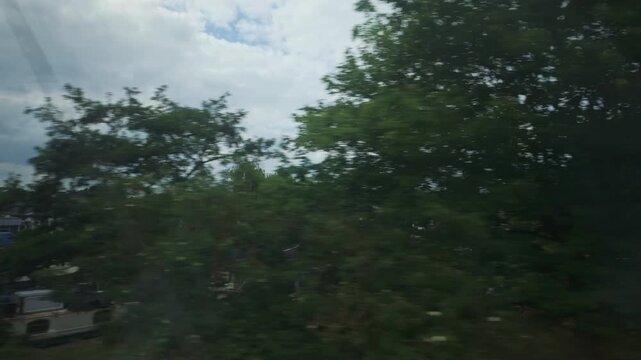 Passenger POV of Narrowboats on the River Great Ouse from a Moving Train, Ely, Cambridgeshire