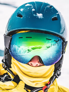 Portrait of snowboarder in helmet and ski goggles in Alps