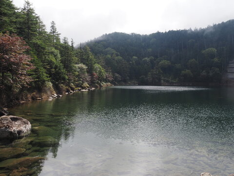 In late September, Mount Kitayokodake in the Northern Yatsugatake range offers a highland mountain landscape of rocky ridges, subalpine conifer forests, and early autumn scenery in Nagano, Japan.
