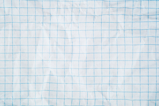 White squared paper texture with blue grid pattern and wrinkled folded surface backdrop