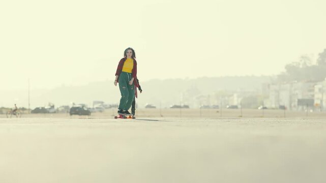 Teenage girls skateboarding and rollerblading together outdoors