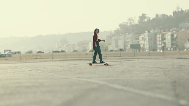Young woman enjoying longboarding in an urban space