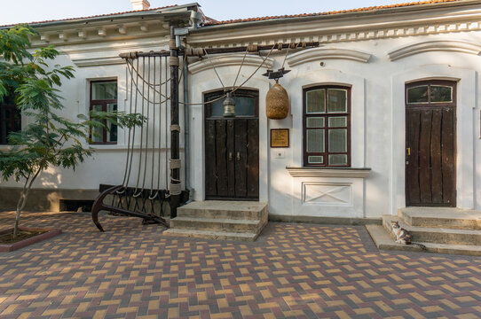 An old-fashioned white house of Alexander Green Literary Memorial Museum has dark brown doors and windows. Entrance is decorated with lanterns and plaques. Feodosia, Crimea &ndash; October 14, 2014