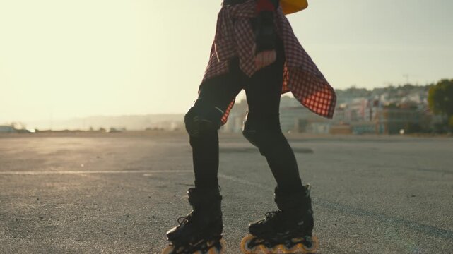 Young person roller skating during sunset