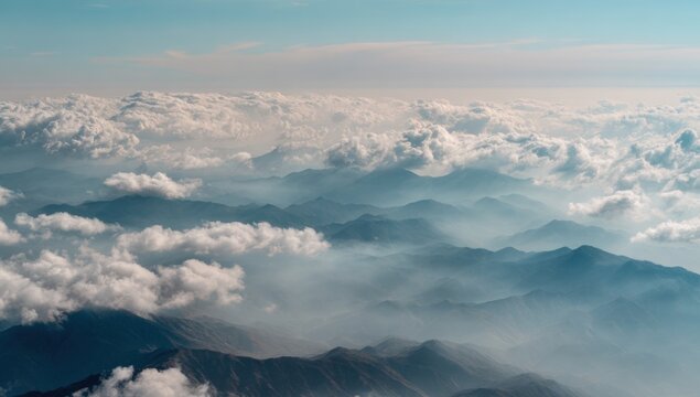 Aerial View of Majestic Mountain Peaks Emerging from a Sea of Clouds.