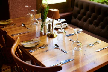 Fotobehang Eetkamer Table setting with glassware and cutlery in restaurant  © khmelev