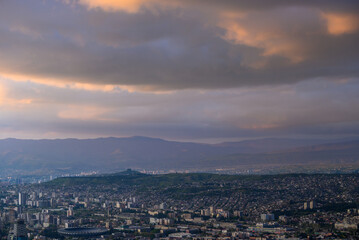 Fototapeta premium Panoramic aerial cityscape sunset view of Tbilisi, the capital of Georgia