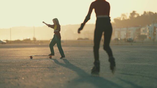 Young woman longboarding and dancing at sunset